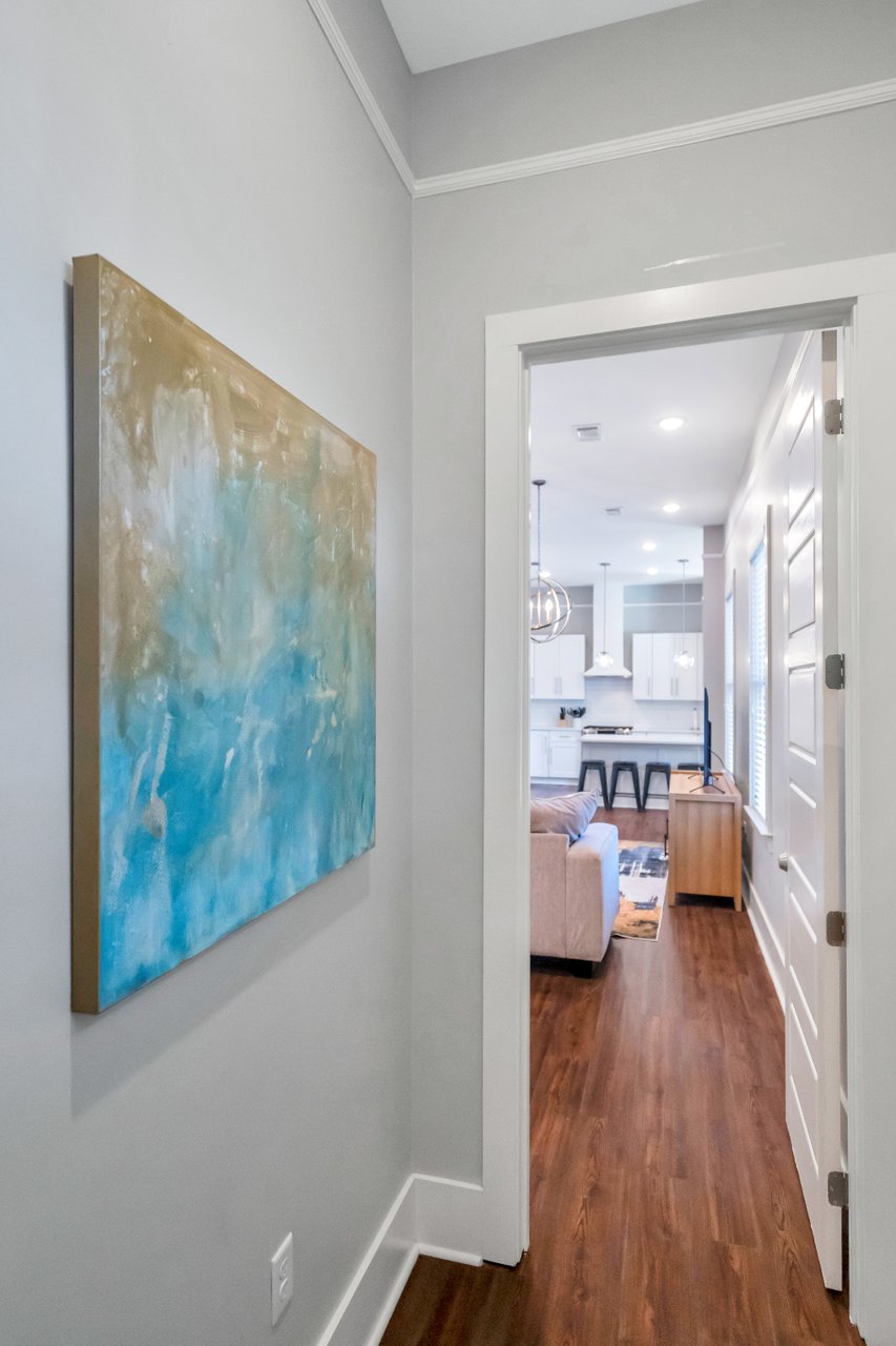 A peek into bright, open living with stylish art and modern finishes.