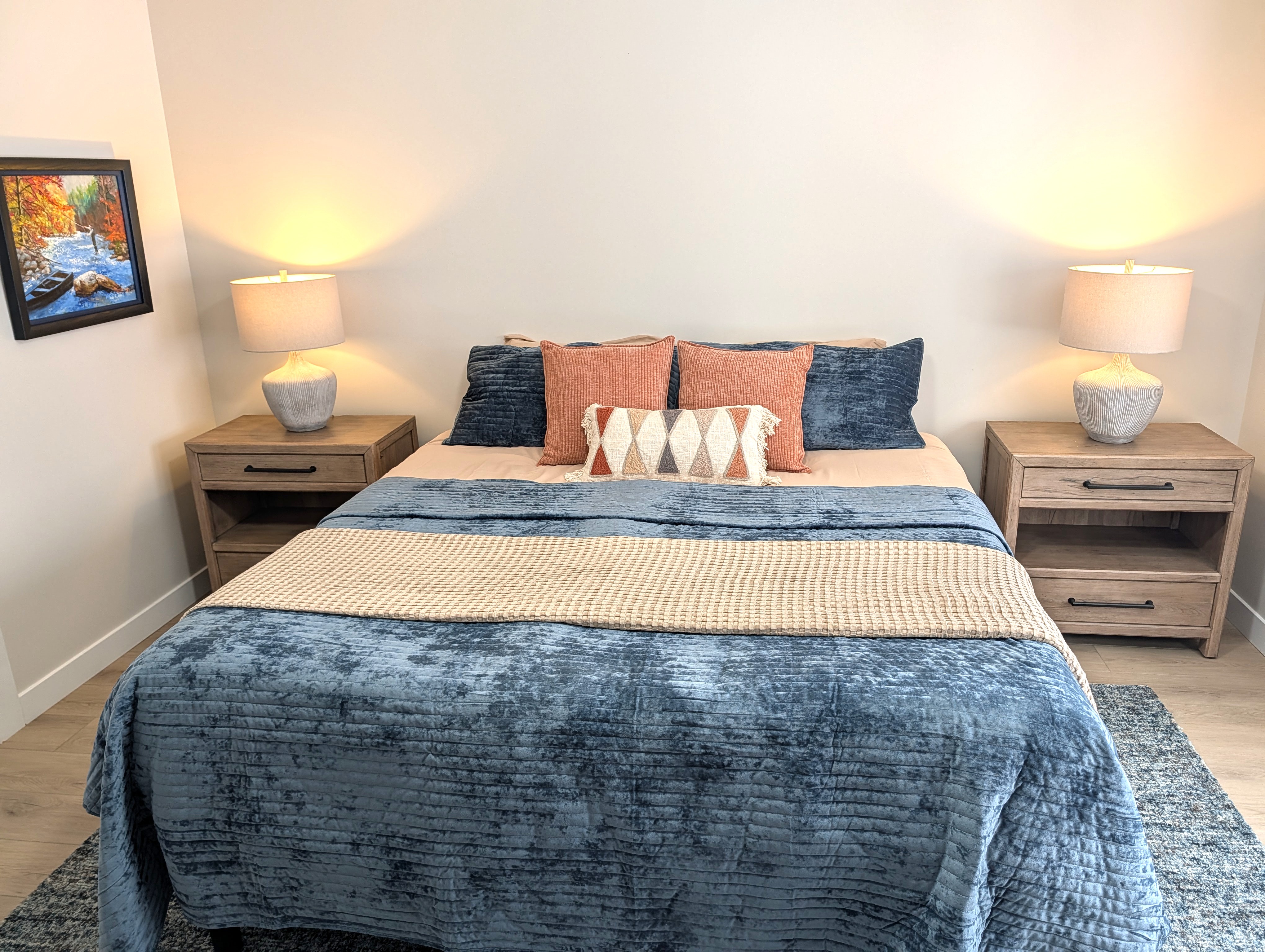 BEDROOM #1 (PRIMARY BEDROOM, MAIN FLOOR):  This is large and beautiful bed featuring a king-size bed, private ensuite full bathroom, private television, dresser, chair, ceiling fan, and closet.
