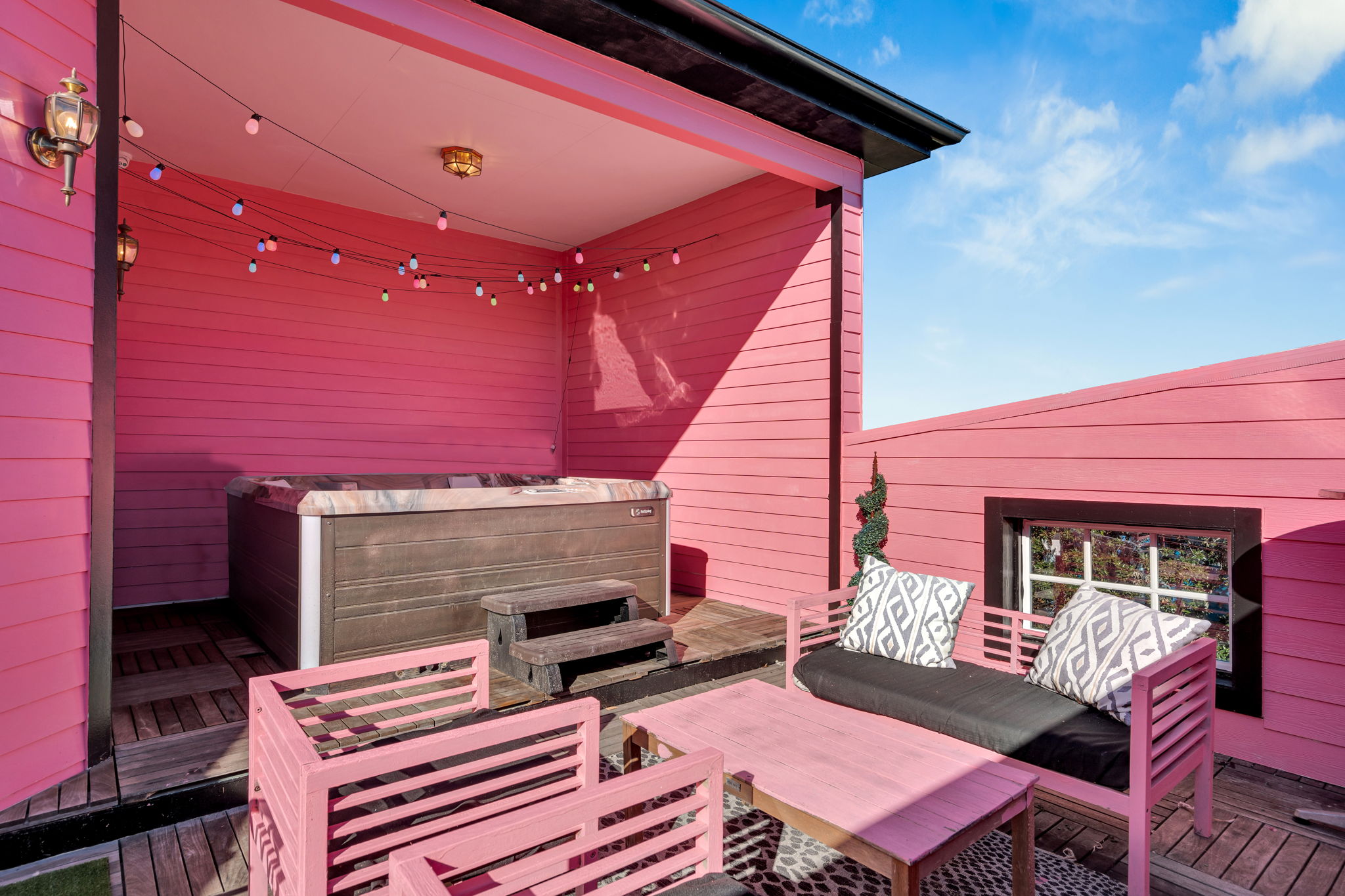 Private pink patio with cozy seating