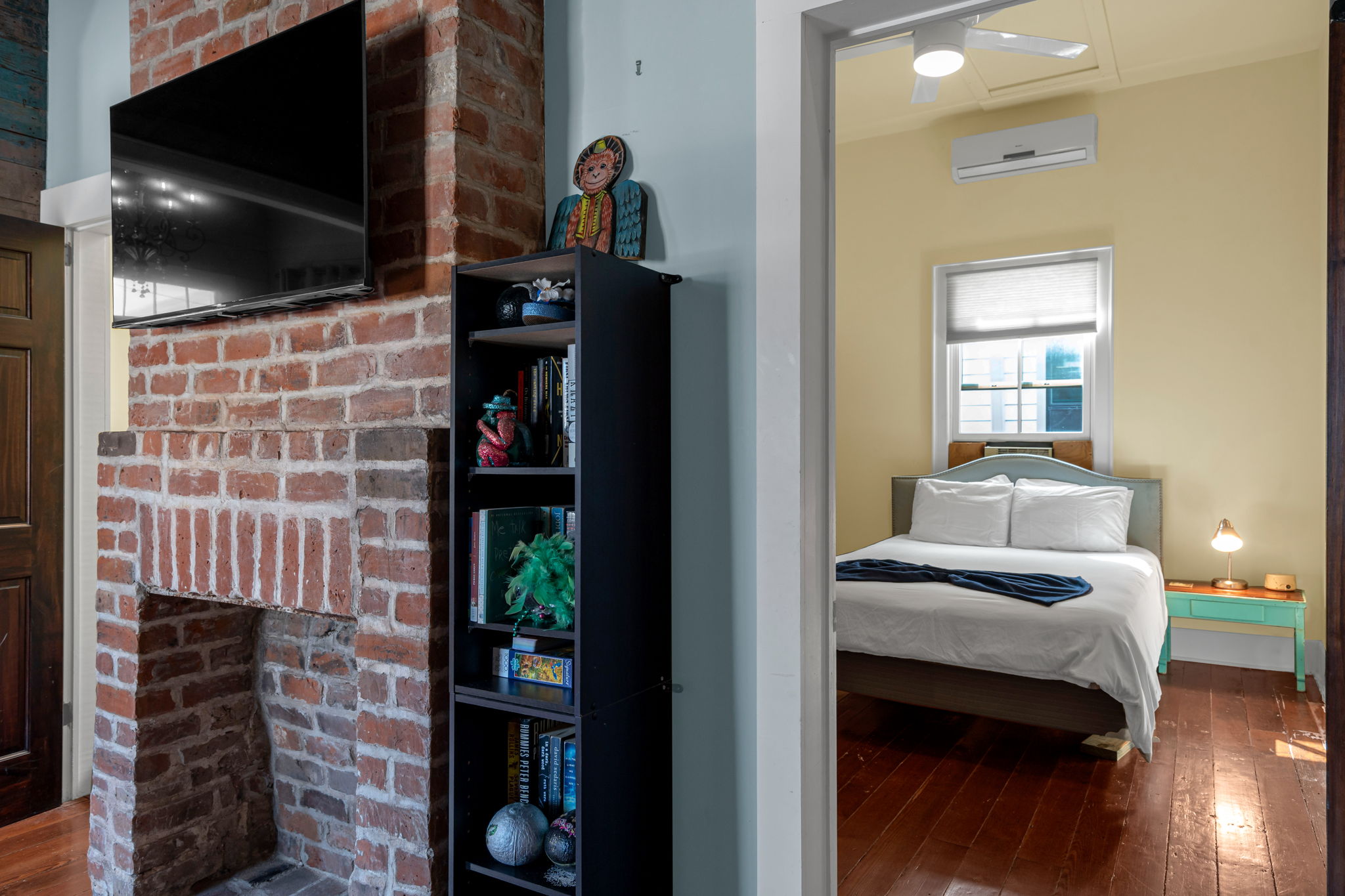 Bedroom-1: Charming exposed brick adds a touch of New Orleans history.