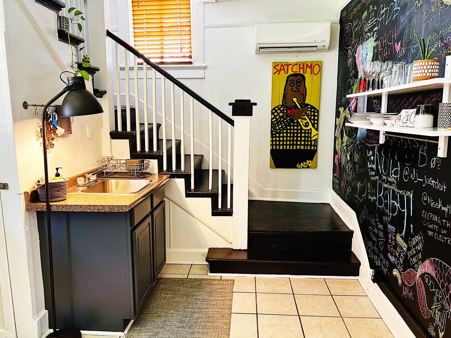 Kitchen sink, with stairs going up to bedrooms and bathroom.

Chalk wall on the right. We welcome guests to draw or write something.
