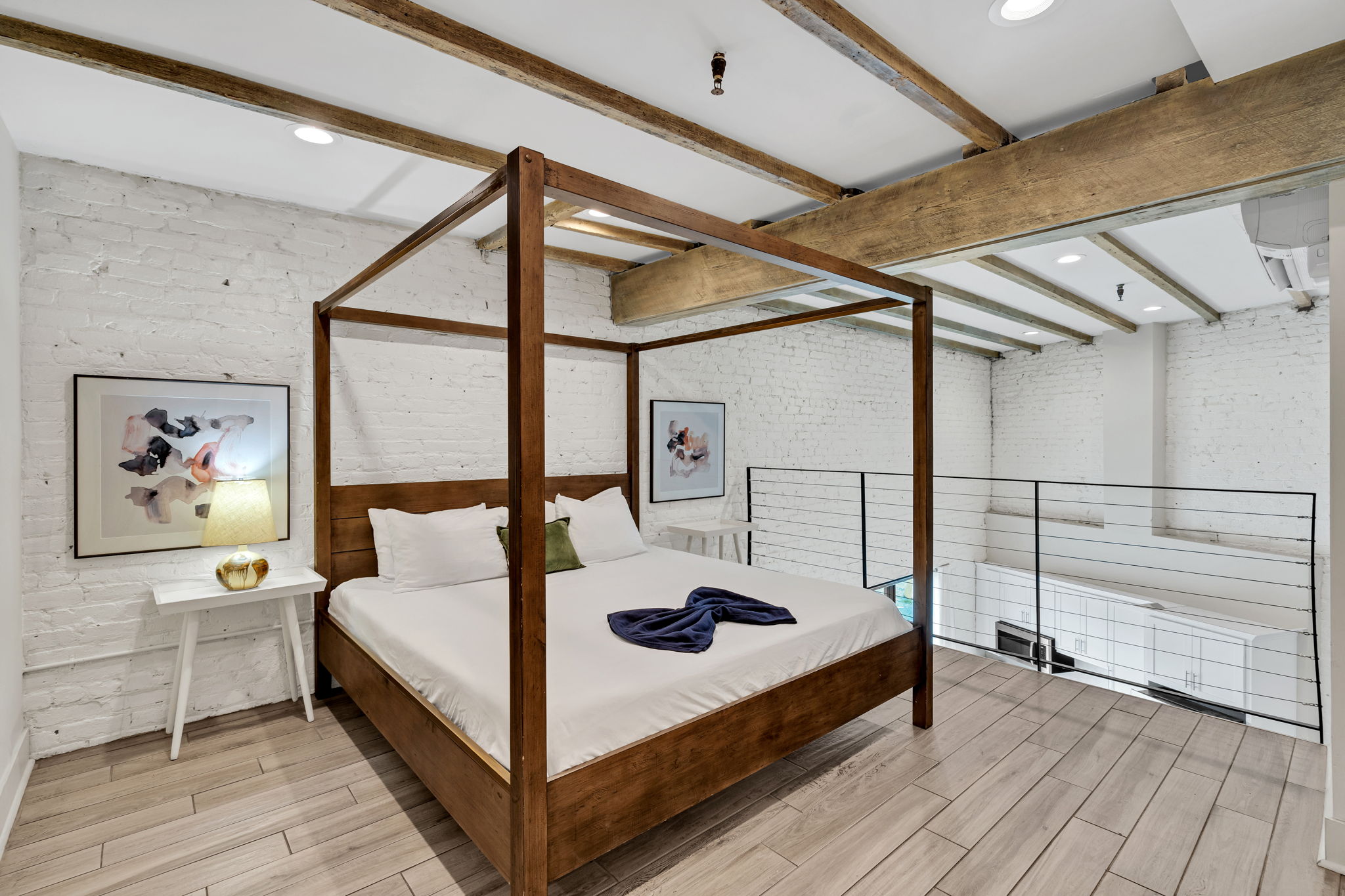 Sunlight pours into the lofted bedroom overlooking the open living room, blending charm and comfort in a space as vibrant and elevated as the Crescent City itself. (unit 2)