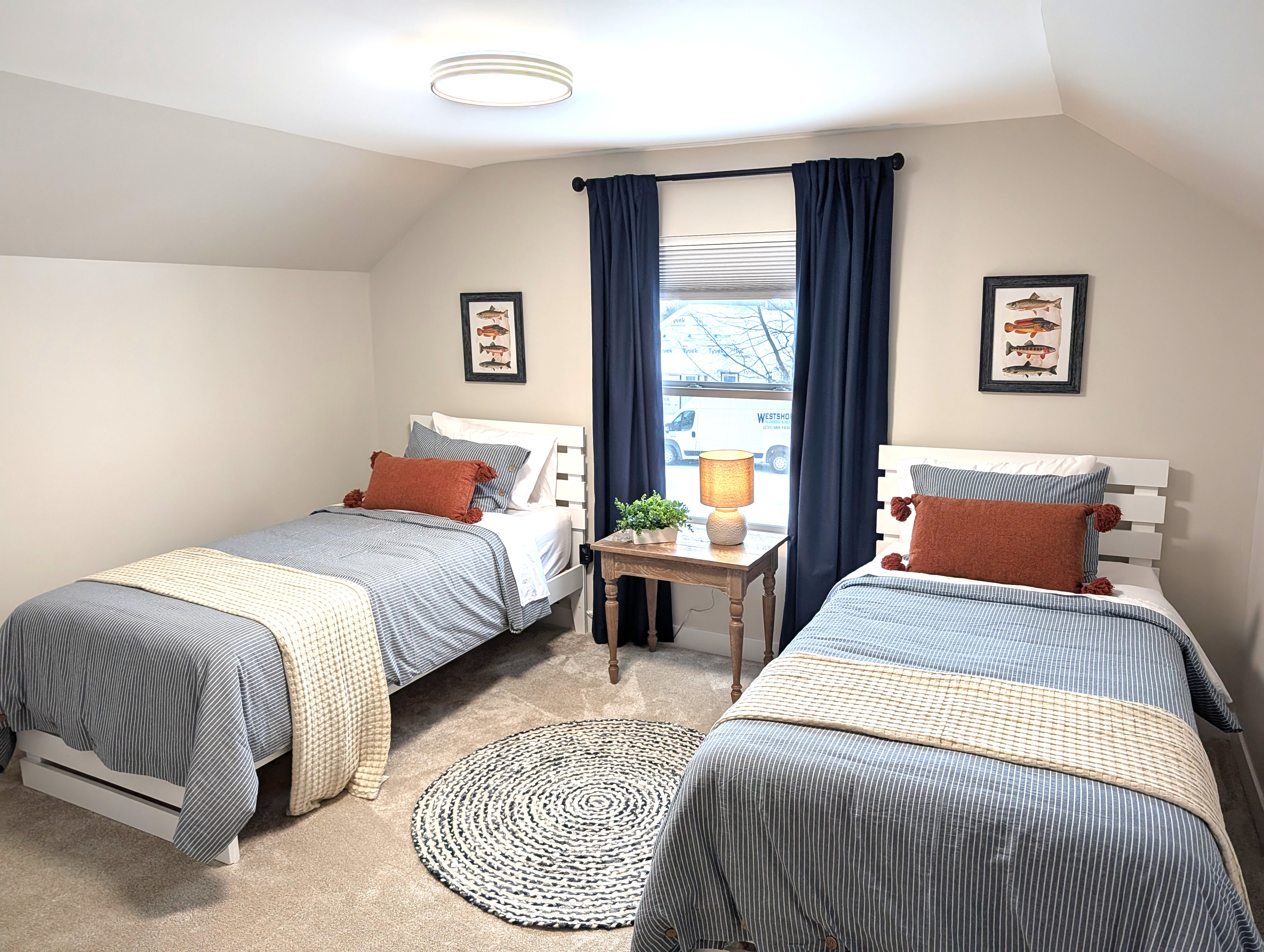 BEDROOM #2 (SECOND FLOOR):  Cute bedroom with two twin beds, table, lamp, dresser, and closet.