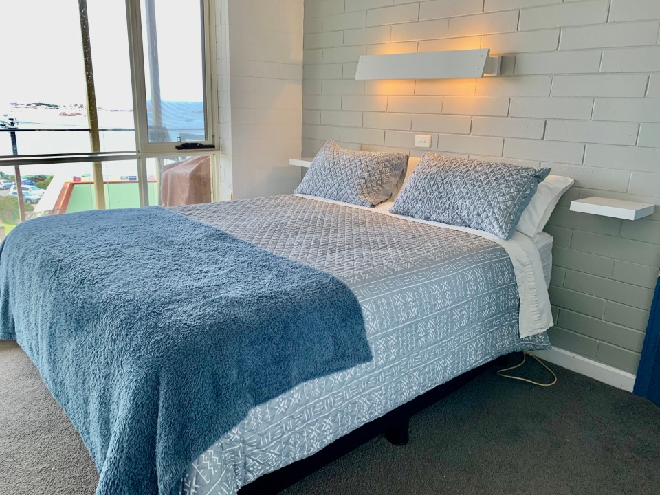 Sleeps up to 5 guests comfortably. Bedroom 1: New queen bed, ocean view, and stylish shelving. Stay cool and comfortable with ducted air conditioning throughout the unit and ceiling fans in each bedroom.
