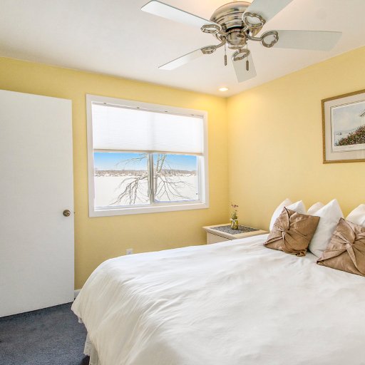 Bedroom 1 — Queen bed with a window over the lake