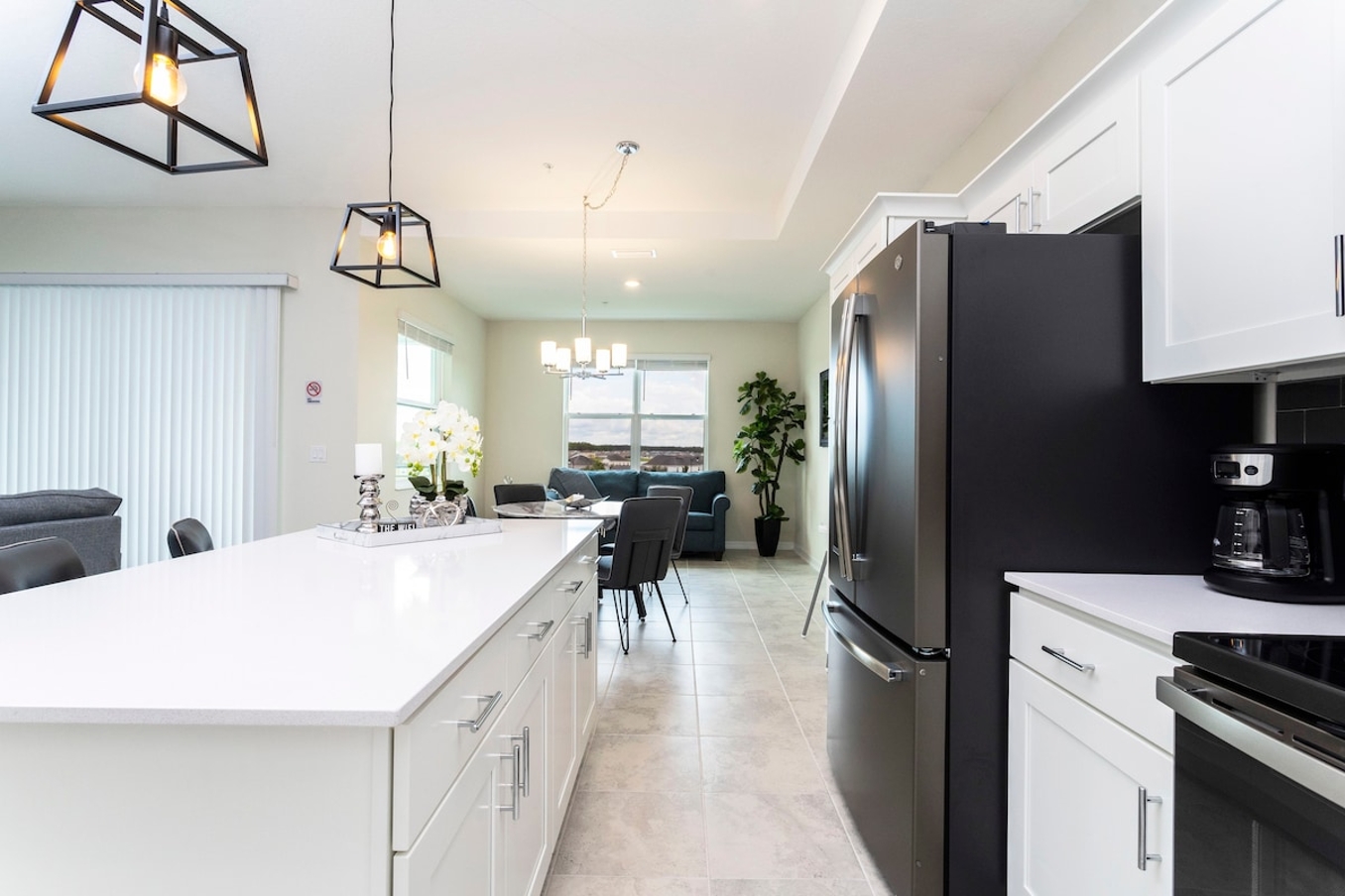 The fully equipped kitchen features modern appliances, sleek cabinetry, and all essential cookware and utensils, making it perfect for preparing meals with ease.