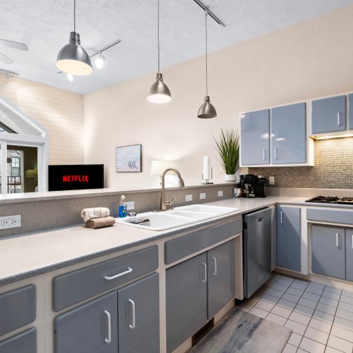 Kitchen opens to the living room and the cathedral window over the balcony.