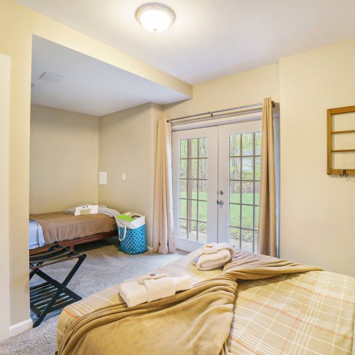Bright and welcoming bedroom featuring both a queen and double bed—perfect for families or groups needing flexible sleeping arrangements