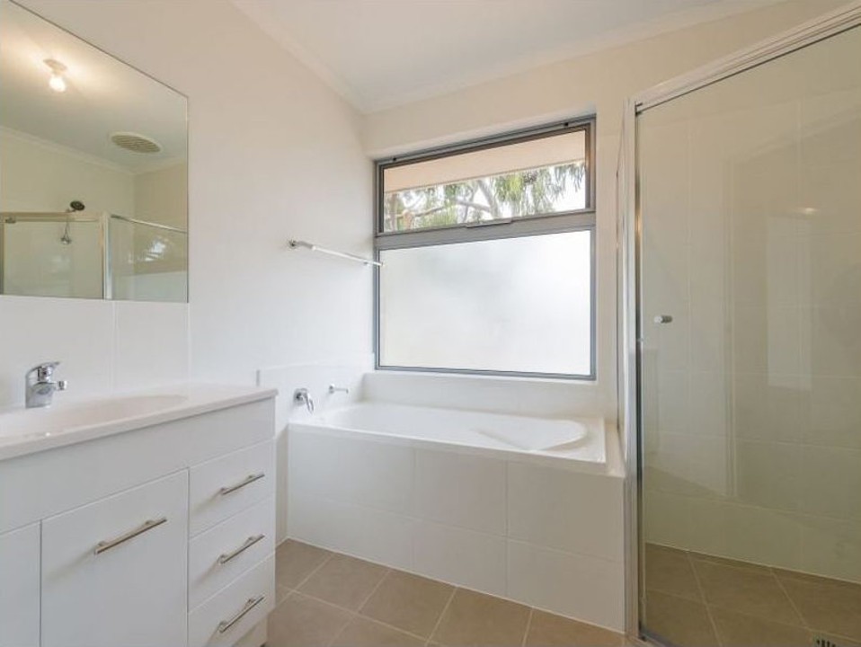 Ensuite bathroom in master bedroom with shower, vanity, and toilet. Main bathroom with separate bathtub and shower — ideal for families or guests needing flexibility.